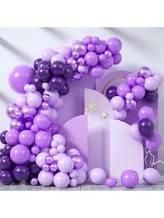 purple and white balloons are in the shape of a castle