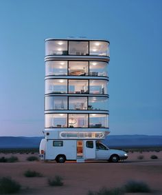 a white bus parked in front of a tall building with windows on it's sides