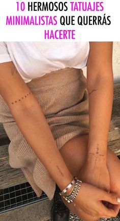 a woman sitting on top of a wooden bench with her arm and leg covered in tattoos