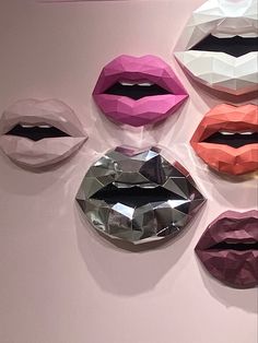 several different colored lips hanging on the wall