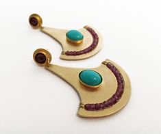 "Unique handmade earrings combines two strong colors - wine red and turquoise with gold. New collection with Shape and color inspired by Ancient Egyptian jewelry. Special big earrings with a bohemian stayle - Make perfect full of style outfit The earringst 24k gold plated combined with natural round 5mm red garnet and8x10mm oval natural turquoise Combined with beautiful 2mm Grant beads. Eerrings Size Top post - 9mm ~1 3/4\" X 1 1/4\" (4.3cmX3.5cm) Total Length ~2\" (5cm) These earrings is part o Gold Bohemian Earrings With Gemstone Accents, Bohemian Turquoise Earrings With Gemstone Accents, Ancient Egyptian Jewelry, Red And Turquoise, Unique Handmade Earrings, Egyptian Jewelry, Bohemian Earrings, Gold Earring, Big Earrings