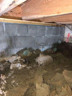 an unfinished room with rocks and dirt on the floor