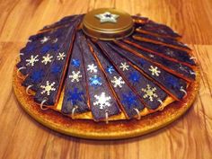 a wooden table topped with a cake covered in snowflakes