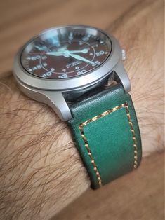 This is a 21mm width strap designed for an 18mm lug width. Made with Seiko 5 Watch owners in mind but looks good on all watches. Succumb to the jaded appeal of this deep green leather watch strap. Cut and stitched by hand, the jewel toned leather watch band is a magnetizing masterpiece.   Spring bars are included. Because these all are handmade straps, please allow for slight variations. Seiko 5, Leather Watch Band, Leather Watch Strap, Leather Watch Bands, Gold Leather, Jewel Tones, Deep Green, Green Leather, Green Gold