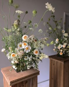 three wooden vases with flowers in them