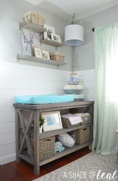 a baby's room with shelves and baskets on the wall