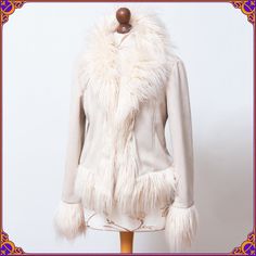 Become the rockstar in this iconic super shaggy afghan jacket! It features a fluffiest faux fur trim with a hidden hook and eye closures. The fabric is an off white/cream acrylic/polyester. It looks wonderful with a vintage suede skirt & gogo knee high boots or casual with jeans ❀ Size M/L  ⫸ IMMACULATE condition! Clean & without any stains or odors. Please see the pictures. ♡ Don't hesitate       to contact me if you would like to see more pictures or have any questions. ⫸ Very unique style ⫸ F Fitted Sheepskin Outerwear For Fall, Bohemian Long Sleeve Fur Coat For Fall, Bohemian Outerwear With Faux Fur Lining And Long Sleeves, Bohemian Outerwear With Faux Fur Lining, Bohemian Long Sleeve Fur Coat, Fitted Winter Outerwear With Feather Trim, Fitted Feather Trim Winter Outerwear, Beige Fringed Winter Outerwear, Winter Sheepskin Outerwear With Feather Trim