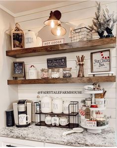 the shelves above the kitchen counter have coffee mugs and other items on them,