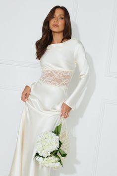 Length from shoulder to hem of size S: 135cm. Chest: 40cm, Waist: 32cm, across front only of size S. Maxi dress. Unlined. Model is a standard XS and is wearing size XS. True to size. Non-stretch. Long sleeve. Lace bodice, sheer/unlined. Tie-up back. Cowl neck/back. Zipper. Cold hand wash only. Polyester. Lovely, this is the classiest dress you need in your events wardrobe. The Queen Visits Long Sleeve Satin Maxi Dress features a sheer lace bodice, and a cowl neck and back with a tie design. Styl Fitted Boat Neck Dress For Date Night, Chic Long Sleeve Bias Cut Dress, Spring Wedding Boat Neck Dress, Fitted Long Sleeve Bias Cut Dress, Chic Long Sleeve Bias Cut Midi Dress, Cream Long Sleeve Midi Dress With Lace Trim, Fitted Long Sleeve Bias Cut Midi Dress, Loose Long Dress, Backless Long Dress