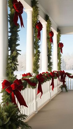 the porch is decorated for christmas with red bows and evergreen garlands on either side