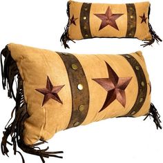 two decorative pillows with stars and fringes on the front, one has a brown leather band