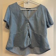 Like New Never Worn Light Blue Shirt With Buttons And Ruffle Short Sleeves. Casual Light Wash V-neck Top, Medium Wash Denim V-neck Top, Casual V-neck Blouse, Trendy Denim V-neck Top, Trendy Light Blue V-neck Blouse, Light Wash V-neck Top For Day Out, Trendy V-neck Denim Top For Summer, Light Blue V-neck Summer Shirt, Medium Wash Button-up Top For Summer