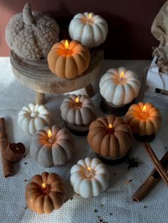 small pumpkins and cinnamon sticks on a table