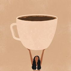 a woman holding up a large cup of coffee with her legs in the air while looking down