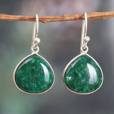 Two drops of vibrant beryl stones in a gorgeous emerald shade are exquisitely encased in polished sterling silver in a design that perfectly blends timeless glamor with bold sophistication. Indian artisan Neetu Barathi creates these striking dangle earrings which perfectly transition from casual to formal occasions, infusing your ensemble with color and radiance. Nickel-free Green Drop Jewelry, Green Nickel-free Drop Jewelry, Green Sterling Silver Teardrop Earrings Hypoallergenic, Green Sterling Silver Teardrop Earrings, Green Sterling Silver Teardrop Earrings Gift, Emerald Drop Gemstone Earrings, Green Teardrop Sterling Silver Jewelry, Emerald Gemstone Drop Earrings, Sterling Silver Drop Earrings For May Birthstone