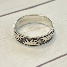 a silver ring sitting on top of a wooden table