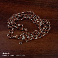 Rudraksha mala with silver  Dimension : - Weight : 6 gram size : 3.5 mm Length of Mala : 16" Inches no. of Beads : 108+1 beads Color : Brown Material : Silver & Rudraksha Product Type : Mala, Necklace The number 108 is significant for so many reasons. Some believe there are 108 stages on the journey of human soul, while others associate the possibility of enlightenment with taking only 108 breath a day while in deep meditation. Spiritually Rudraksha mala have been used for meditation since centuries. One legend say that once when Lord Shiva opened his eyes after a long period of yogic meditation, he felt sense of extreme fulfilment. It made him shed a tear. This single tear from Shiva eyes grew into Rudraksha beads are believed to promote inner peace, knowledge, power and enlightenment. Th Spiritual Necklaces With Silver Beads For Puja, Spiritual Silver Beaded Necklaces For Puja, Spiritual Silver Beads Mala Gift, Spiritual Silver Mala With 8mm Beads, Silver Spiritual Mala For Puja, Silver Spiritual Beads For Festivals, Silver Mala With 108 Beads As Gift, Silver Mala With Round Beads For Meditation, Handmade Silver Mala Spiritual Style