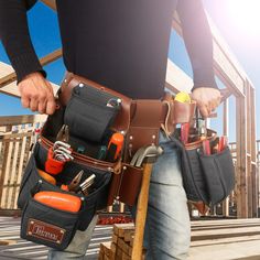 a man holding his tool belt full of tools