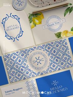 some blue and white business cards with lemons on them next to a bowl of fruit