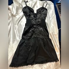 Moschino Black Corset Lace Up Dress With Lace Trim Excellent Vintage Condition Size Small Black Satin Underbust Corset Dress, Elegant Black Underbust Corset Dress, Black Satin Mini Length Corset Dress, Black Satin Corset Dress For Night Out, Black Gothic Satin Dress, Black Satin Dress For Costume Party, Black Gothic Underbust Dress, Black Underbust Corset Dress, Black Underbust Mini Dress