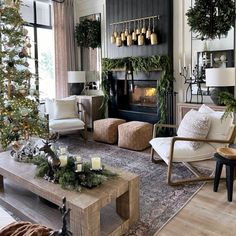 a living room filled with furniture and a christmas tree in front of a fire place