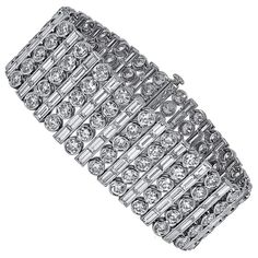 This bracelet is designed with 115 pieces of baguette cut diamonds with the total carat weight of 18.65 together with 115 pieces of round diamonds with the total carat weight of 21.59. Sophia D by Joseph Dardashti LTD has been known worldwide for 35 years and are inspired by classic Art Deco design that merges with modern manufacturing techniques. Expensive Bracelets, Modern Bangle, Expensive Diamond, White Gold Bangle, Diamond Bracelet Design, Flawless Diamond, Expensive Jewelry Luxury, Vintage Jewellery Rings, High Fashion Jewelry