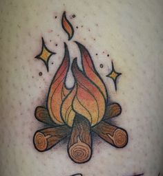 a tattoo with a campfire and stars on it