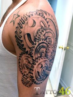 a man with a clock and gears tattoo on his arm