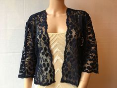 This is a beautiful hand made navy blue lace jacket ideal for weddings or special occasions. The shrug has 3/4 length sleeves. It can also be worn with casual wear. It can be made in any size from 8 to 24 (UK sizes). It is made in the UK. It is normally sent out to you within 5 days, but I am very happy to make your order a priority if you need it urgently. Just let me know the date needed by. Postage is free in the UK! International postage is £9. I am happy to exchange items or refund your pay Elegant Navy Long Sleeve Cardigan, Elegant 3/4 Sleeve Cardigan For Party, Chic Fitted 3/4 Sleeve Shrug, Fitted 3/4 Sleeve Party Shrug, 3/4 Sleeve Cardigan For Fall Party, Elegant Blue Formal Cardigan, 3/4 Sleeve Fall Cardigan For Party, Elegant Blue Summer Cardigan, Evening Fitted Shrug With Lace Sleeves