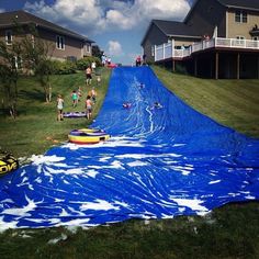 an inflatable water slide is being pulled down the hill