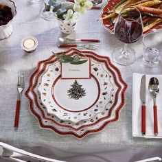 a table set for christmas with silverware and napkins