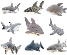 several stuffed sharks are shown together on a white background