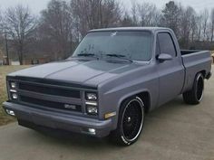 a gray truck parked on top of a driveway