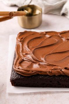 a square cake with chocolate frosting on top