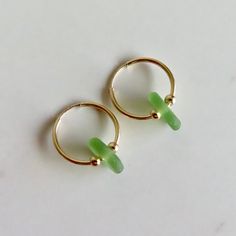 Seaglass Hoop Earrings~ These cute small endless hoops have light green seaglass and gold beads, great gift for the beach lover. Hoops 16mm. *This listing is for the earrings in the first photo ready to ship **video shows 20 and 24mm. hoops Shop~ http://www.etsy.com/shop/HanaMauiCreations?ref=pr_shop_more International buyers please read our shipping policies before ordering~ POLICIES~ https://www.etsy.com/shop/HanaMauiCreations/policy?ref=shopinfo_policies_leftnav Glass Hoop Earrings, Green Hoop Earrings For Gifts, Green Hoop Earrings, Summer Gift, Green Hoop Earrings As Summer Gift, Green Hoop Earrings For Summer, Glass Hoop Earrings As Gift, Glass Hoop Earrings For Gift, Green Small Hoop Jewelry For Summer, Adjustable Small Hoop Jewelry For Beach