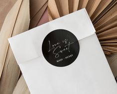 a close up of a envelope with writing on it and a fan in the background