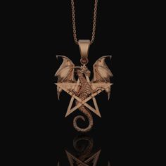 a necklace with an image of a dragon and pentagramus on the front, against a black background