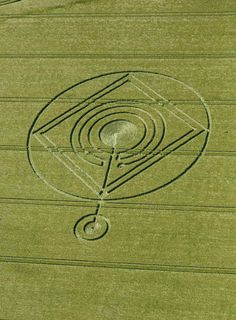 an aerial view of a field with circles and lines in the center, on top of it