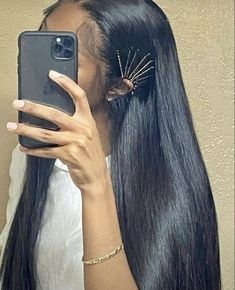 a woman taking a selfie with her hair in front of her face and wearing a white shirt