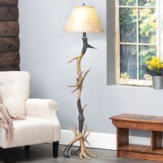 the antler lamp is next to a white chair