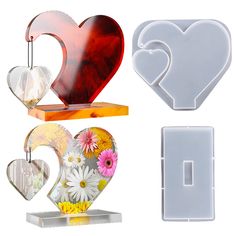 three heart shaped cookie cutters, one with flowers and the other with hearts