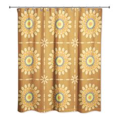 an orange shower curtain with yellow and blue flowers on it