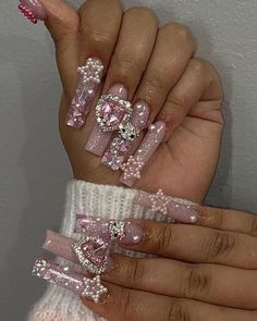 a person with pink and white nail designs on their nails