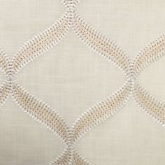 an upholstered white and beige fabric with diamond design on it's side