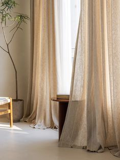 a living room with curtains and a table