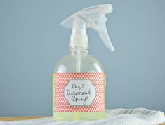 a close up of a bottle of soap on a table with a cloth and towel