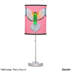 a pink lamp with a green bird on it