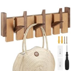 a white purse sitting next to a wooden coat rack