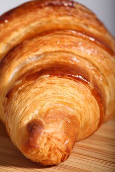 a croissant sitting on top of a wooden table