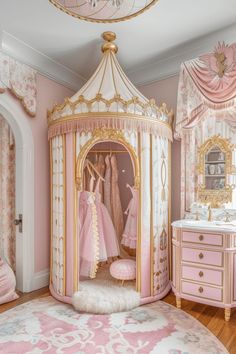 a pink and gold girls'bedroom with princess beds, dressers and dressing table